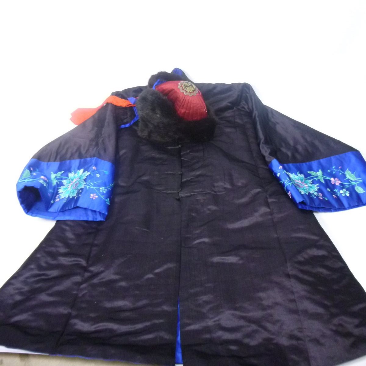 CHINESE SILK WINTER COATthe black silk trimmed with decorative foliate sleeve panels, with a label