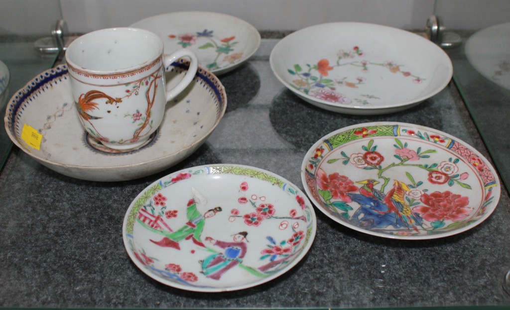 A selection of four 18th century Chinese famille rose saucers, one cup, export saucer with various