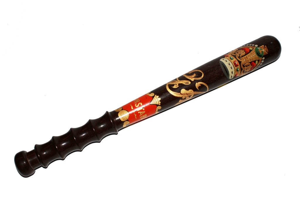 A Georgian hardwood constable`s truncheon with shaped handle depicting the Royal Insignia