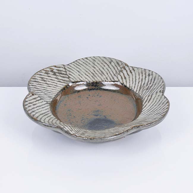 Shimaoka Tatsuzo (Japanese, 1919-2007) Flower Dish Stoneware, the petalled rim with diagonal