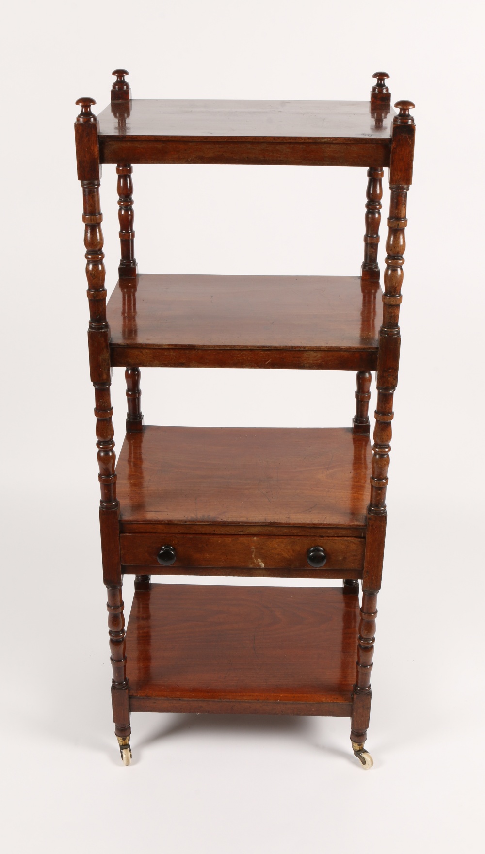 A VICTORIAN MAHOGANY FOUR TIER WHATNOT with turned supports and single drawer to the central tier,