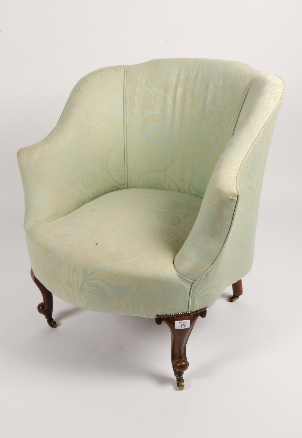 AN EARLY 20TH CENTURY TUB CHAIR with short cabriole front legs terminating in scroll feet and
