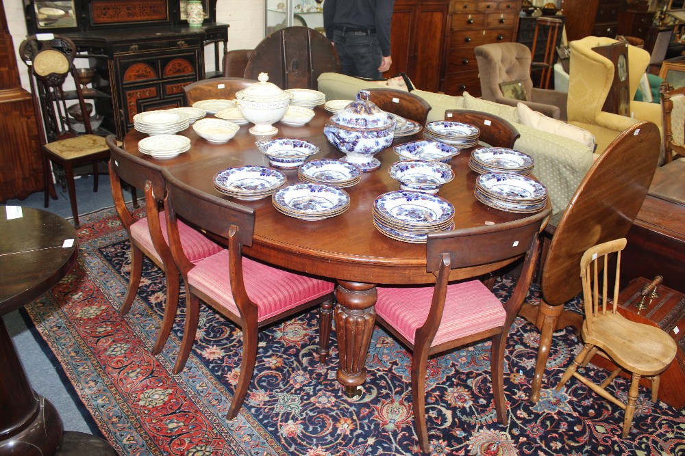 A MAHOGANY EXTENDING D END DINING TABLE with reeded tapering legs and four extra leaves,