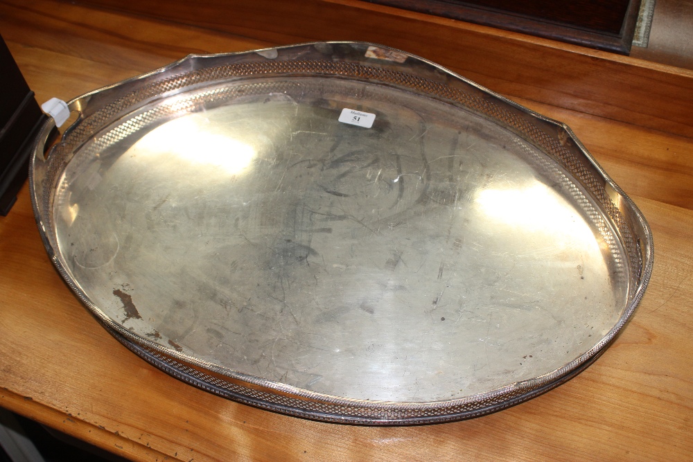 A SILVER PLATED OVAL TRAY with pierced undulating galleried sides and standing on four feet, 61.5cm