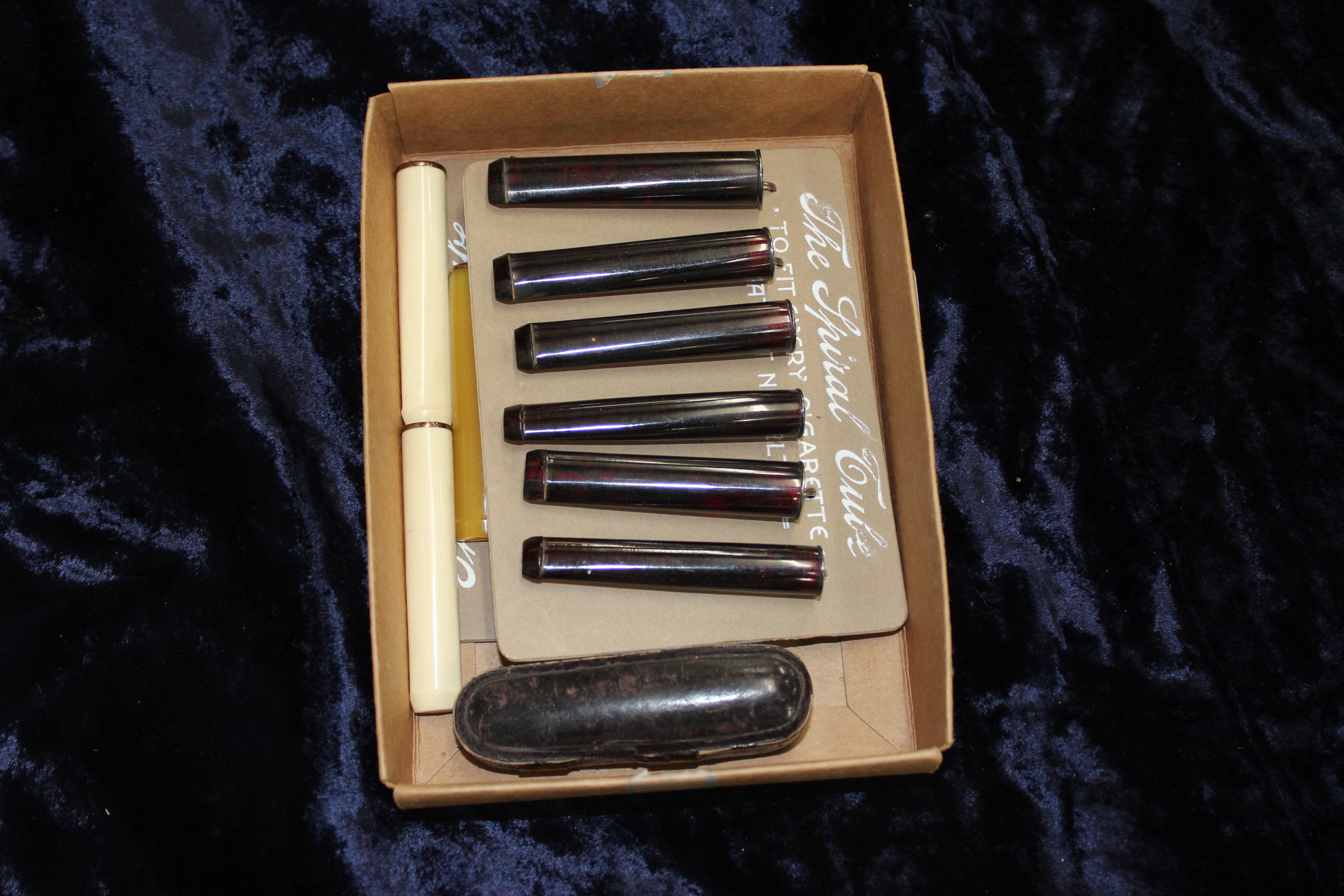 A COLLECTION OF BAKELITE CIGARETTE HOLDERS