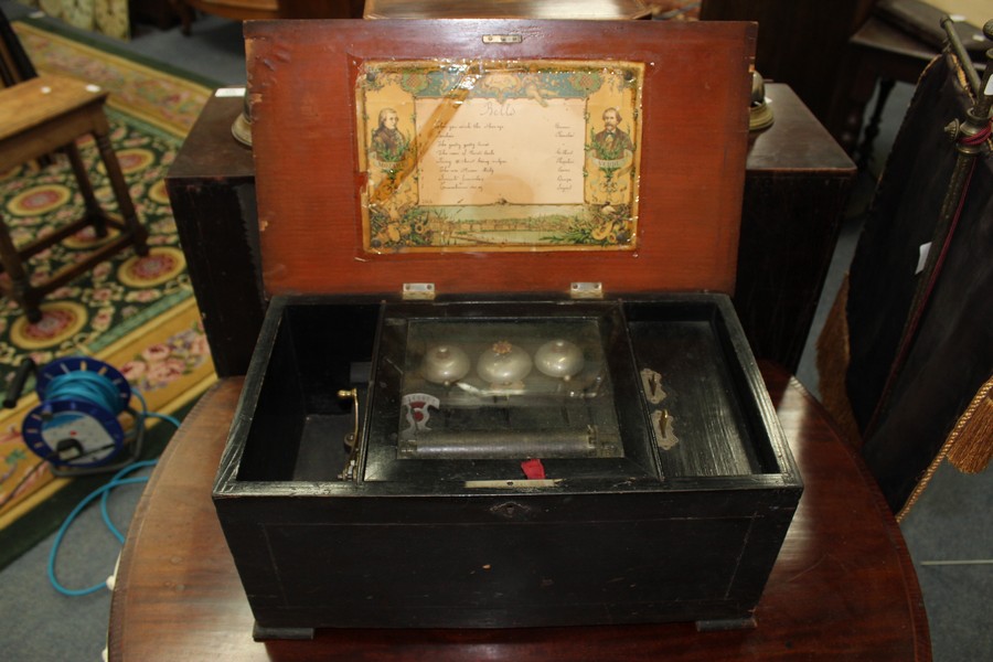 A LATE 19TH CENTURY SWISS CYLINDRICAL MUSIC BOX with three striking bells, 47cm wide