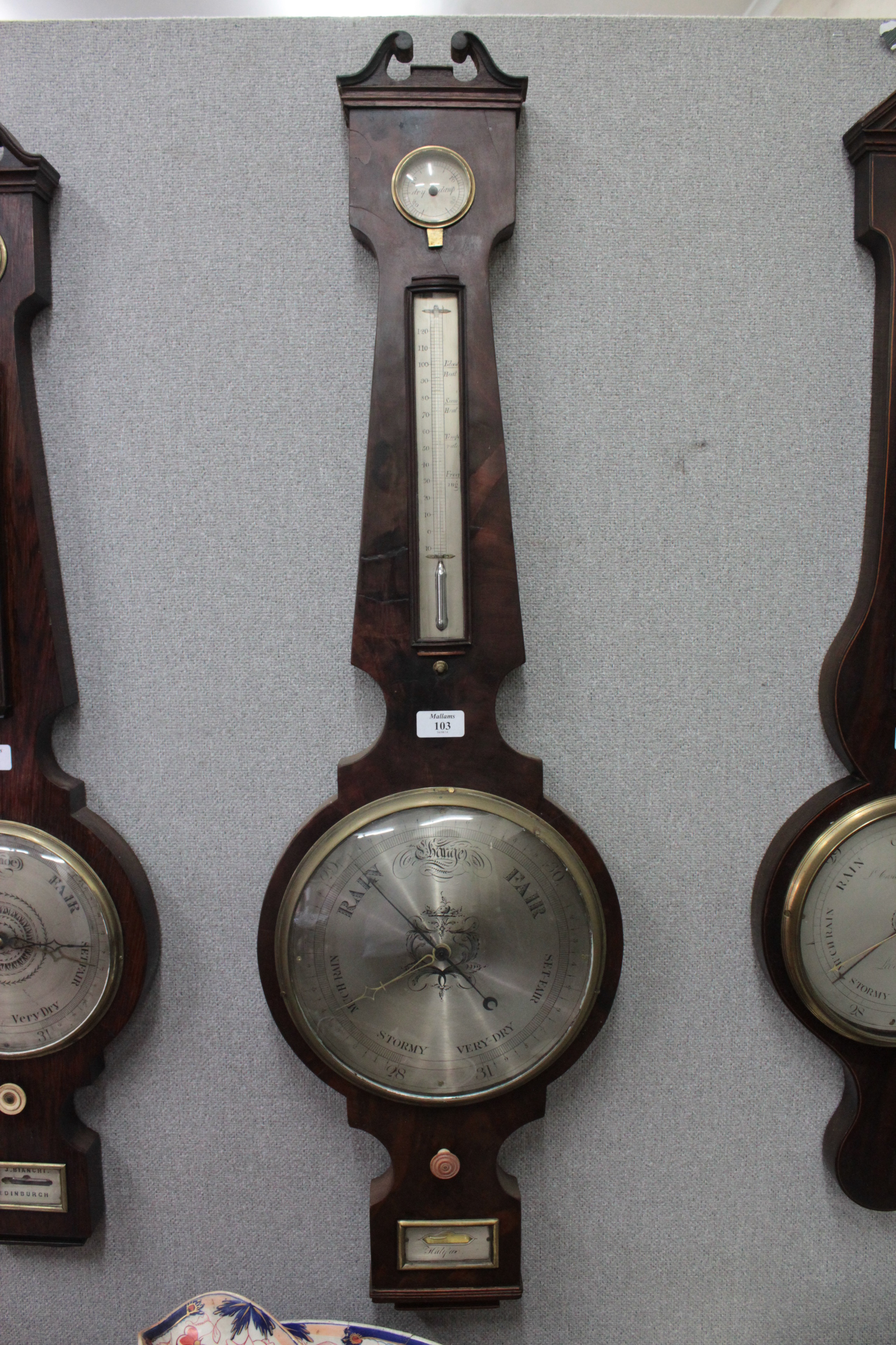 A 19TH CENTURY MAHOGANY WHEEL BAROMETER, the swan neck pediment over a hygrometer, spirit tube