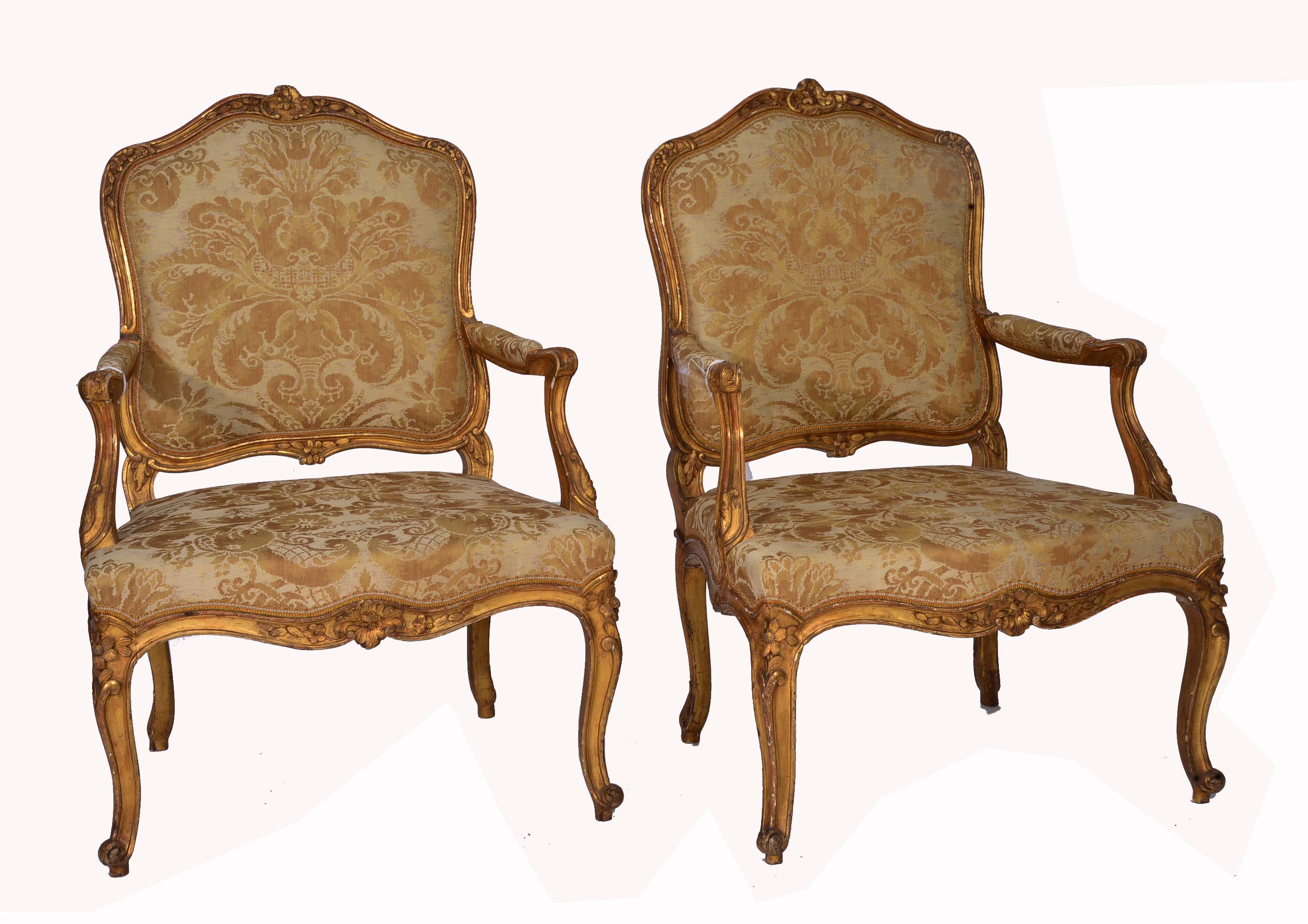 A PAIR OF LOUIS XV STYLE GILT WOOD FAUTEUILS with carved foliate decoration, open arms, serpentine