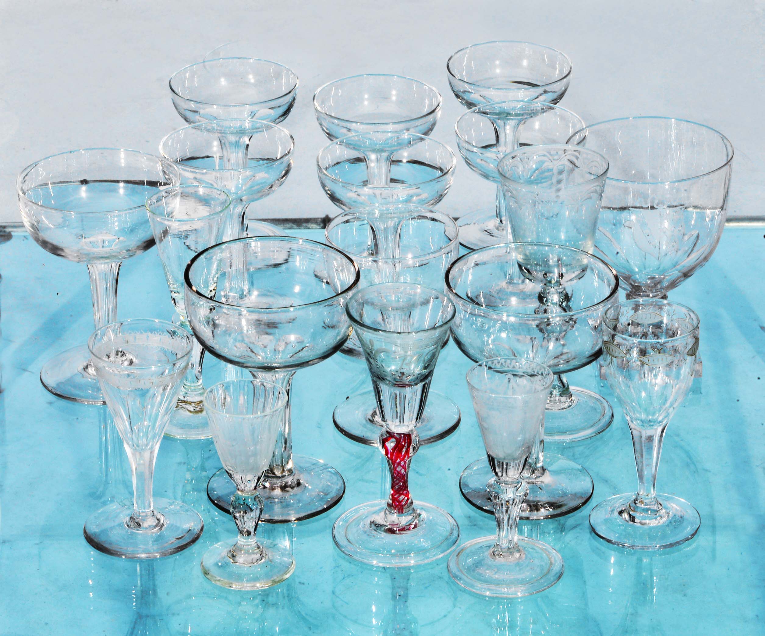 A COLLECTION OF EIGHTEEN OLD DRINKING GLASSES including a set of six champagne flutes