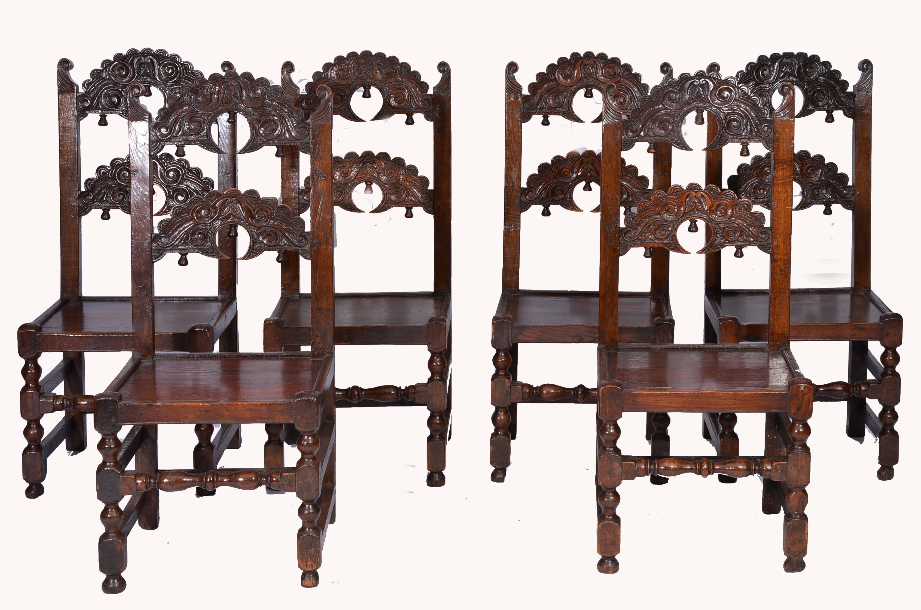 A SET OF SIX 17TH CENTURY STYLE OAK DINING CHAIRS with scroll carved horseshoe horizontal splat