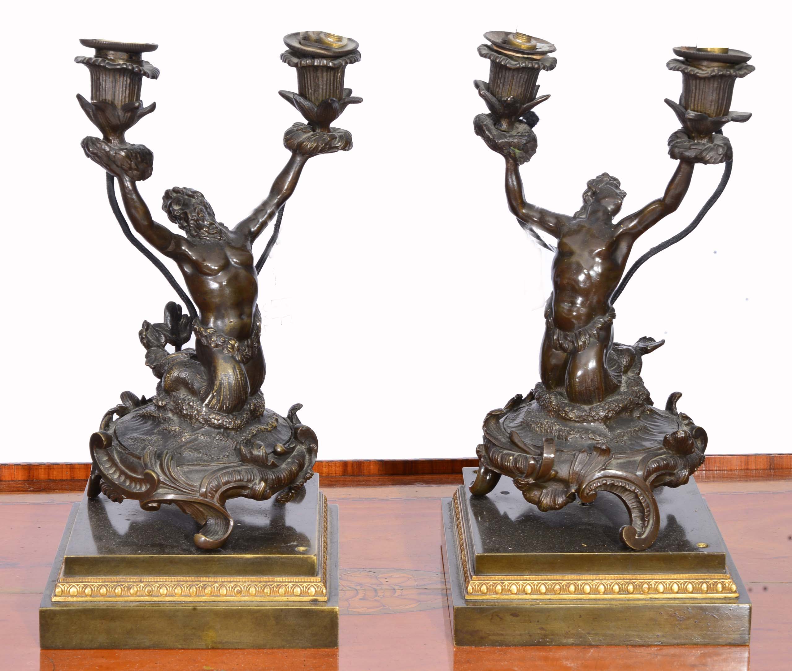 A PAIR OF ITALIAN BRONZE  LAMPS in the form of half man and half sea creature on acanthus square