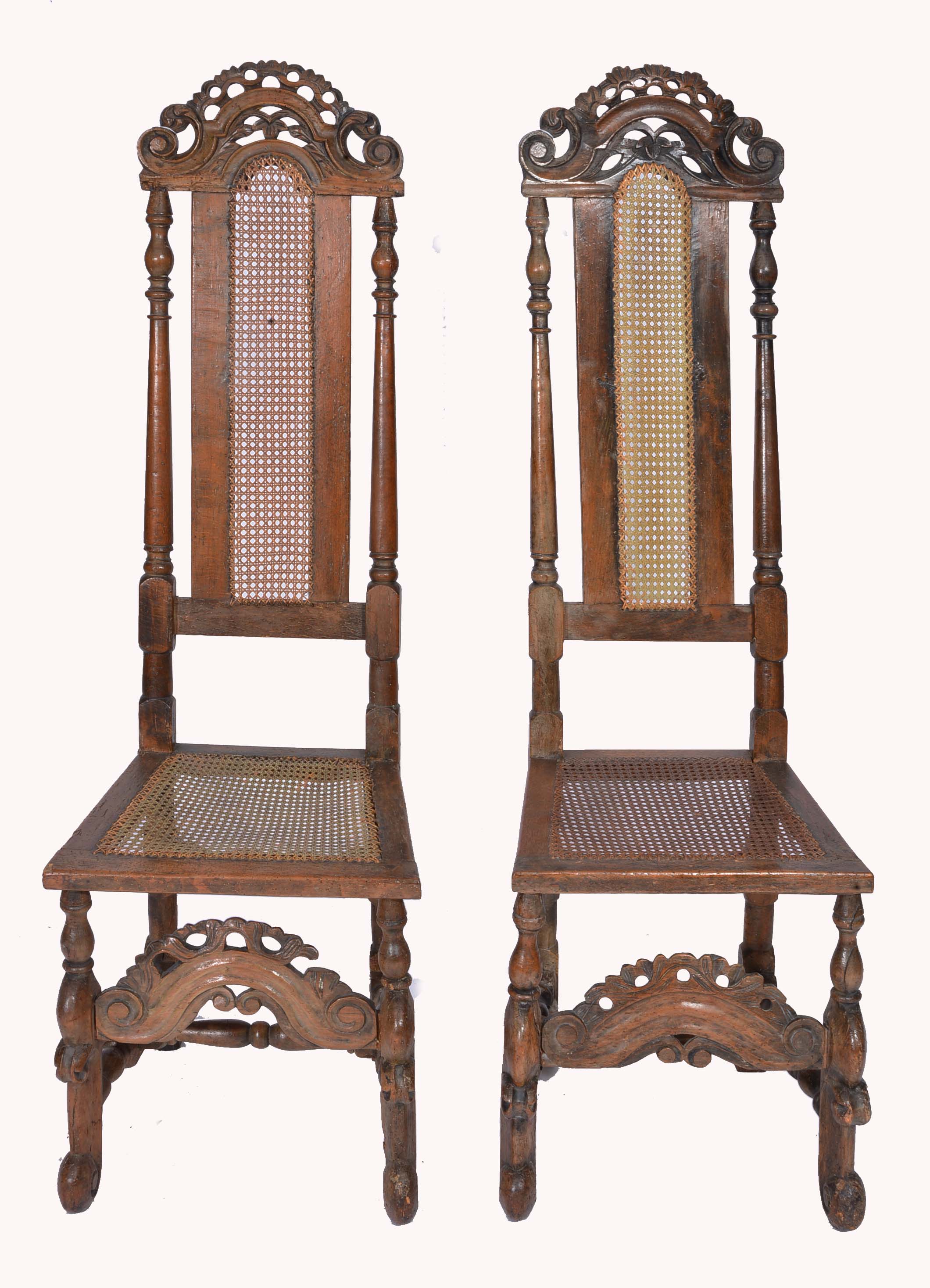 A PAIR OF WILLIAM AND MARY WALNUT HIGH BACK REFECTORY CHAIRS with carved cresting rails, cane seat