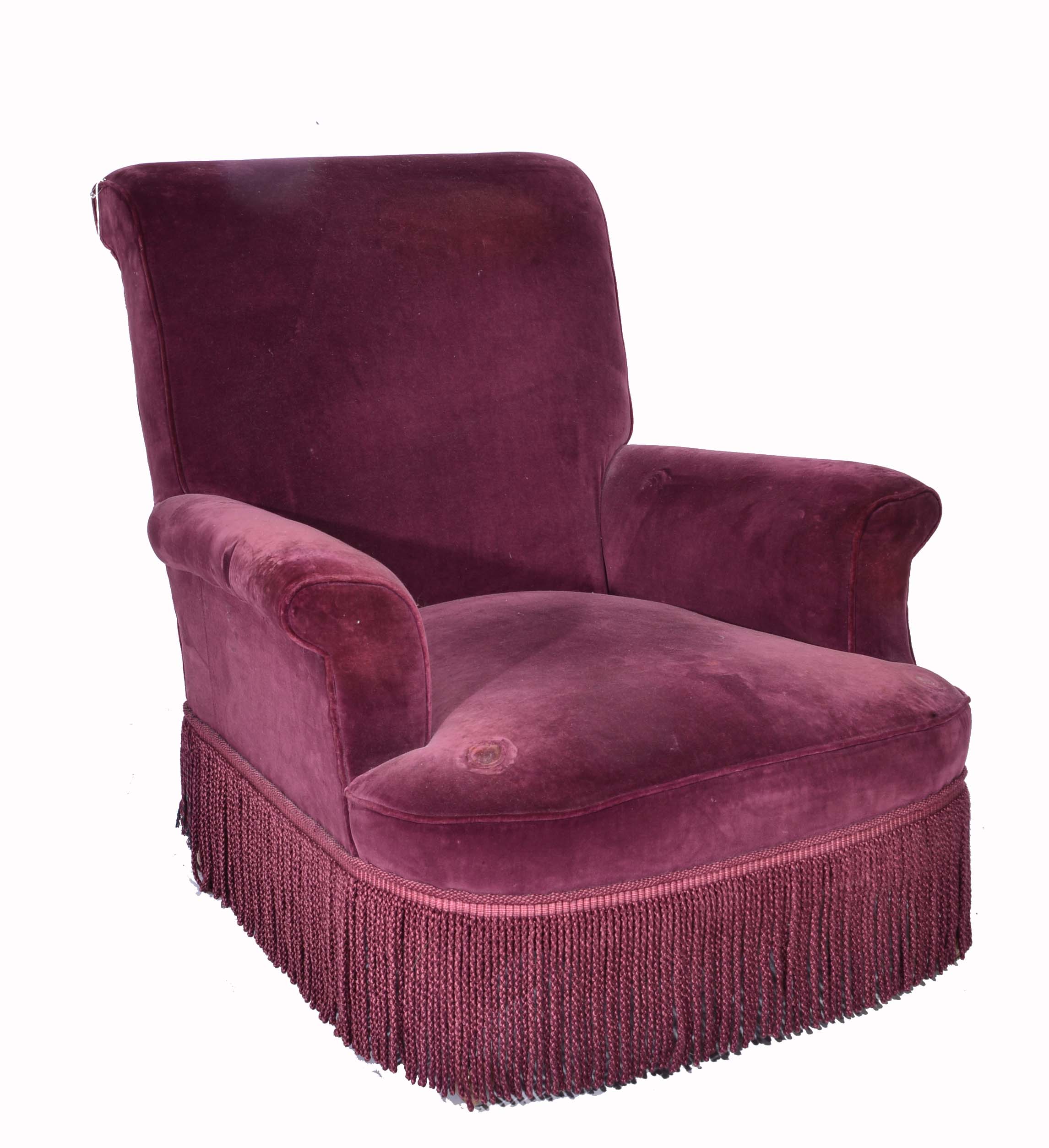 A CLUB ARMCHAIR upholstered in cardinal purple with tassel edge and mahogany turned four legs,