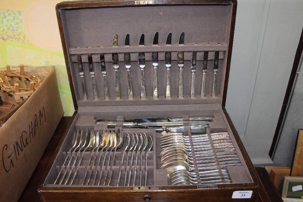 A MAPPIN & WEBB OAK CASED CANTEEN of silver plated cutlery, six settings of fork spoons, knives, a