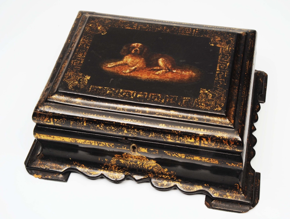 AN EARLY 19TH CENTURY PAPIER MACHE SEWING BOX, hinged lid, painting of a dog, scrolled in gilt