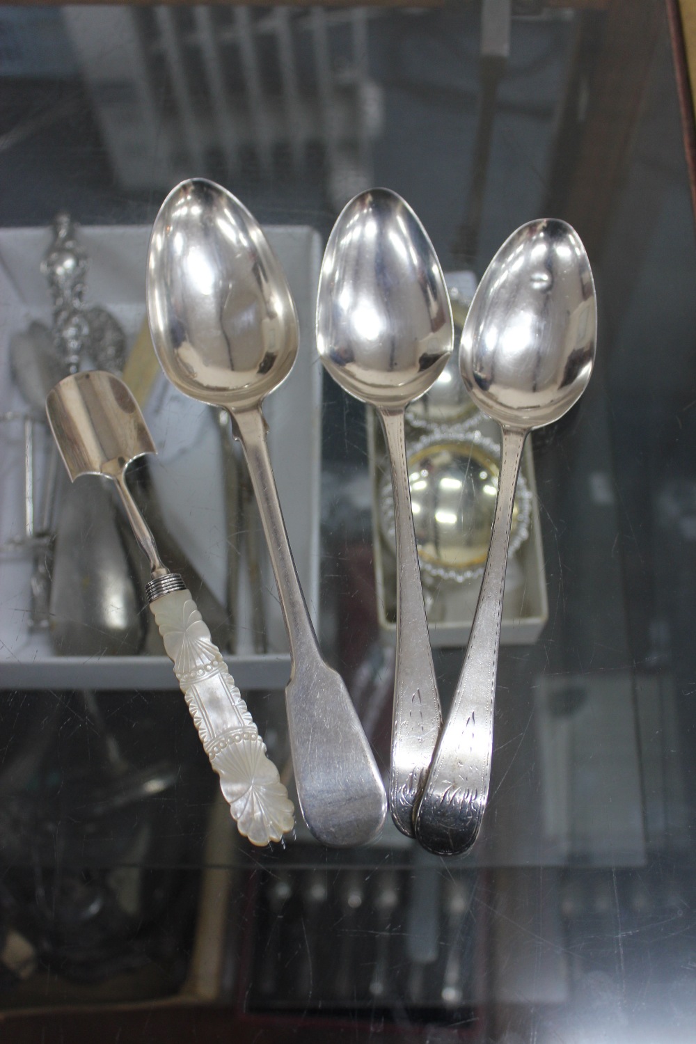 A GEORGIAN SILVER TABLESPOON marked with London 1821 makers mark of WEWF to go with various silver
