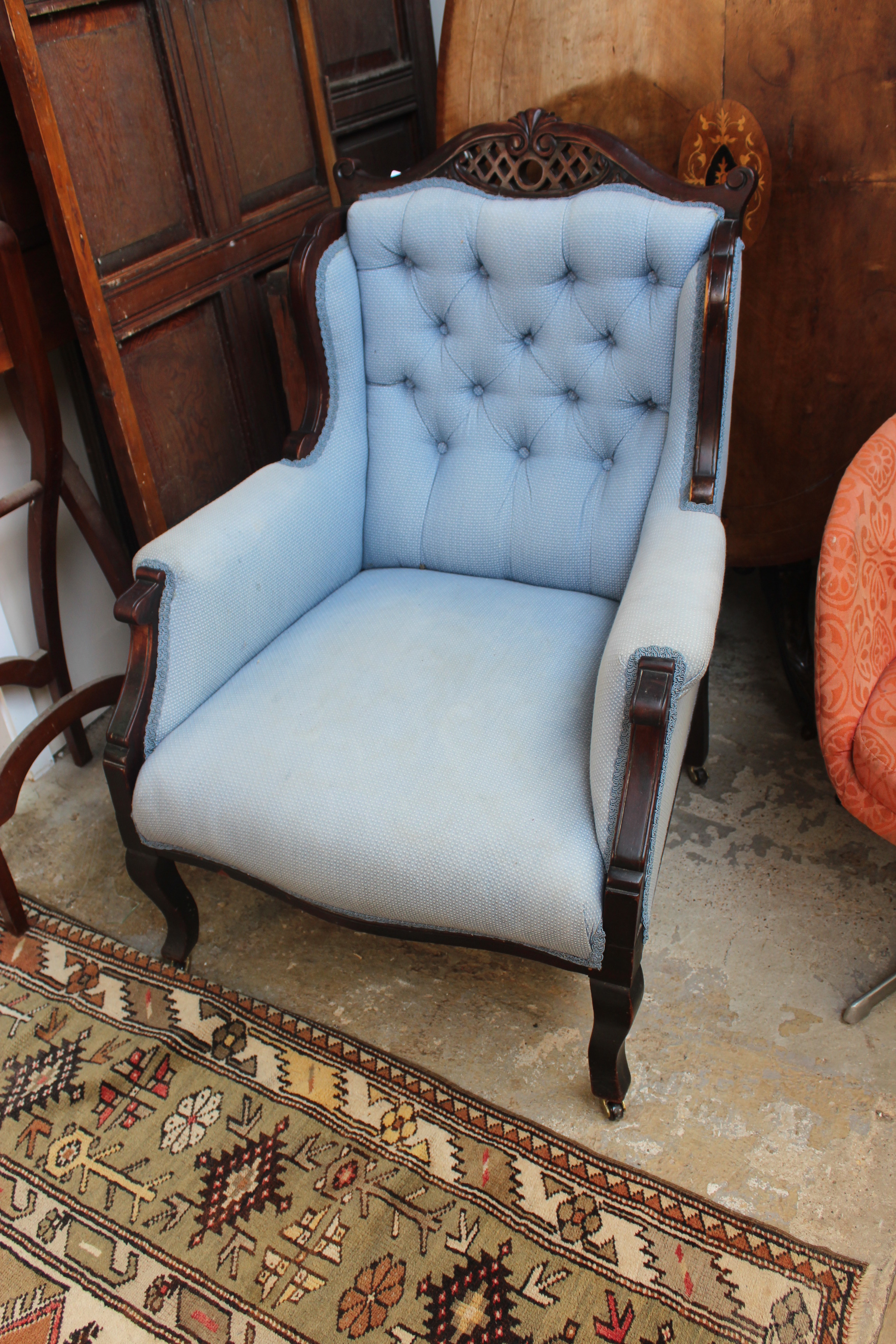 A PAIR OF MAHOGANY BLUE BUTTON UPHOLSTERED ARMCHAIRS with wing backs and shaped legs, 69cm wide