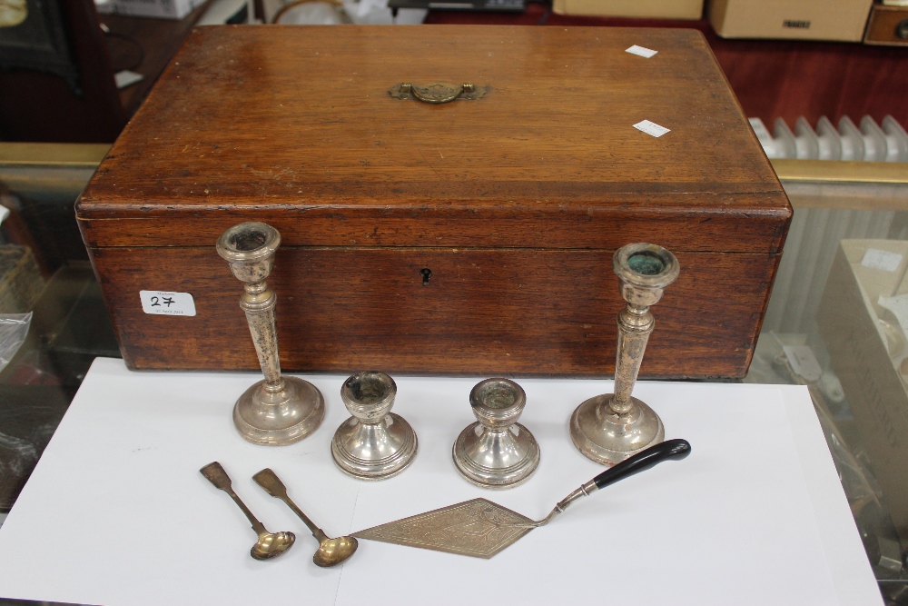 TWO PAIRS OF SMALL LOADED SILVER CANDLESTICKS together with two silver Victorian mustard spoons