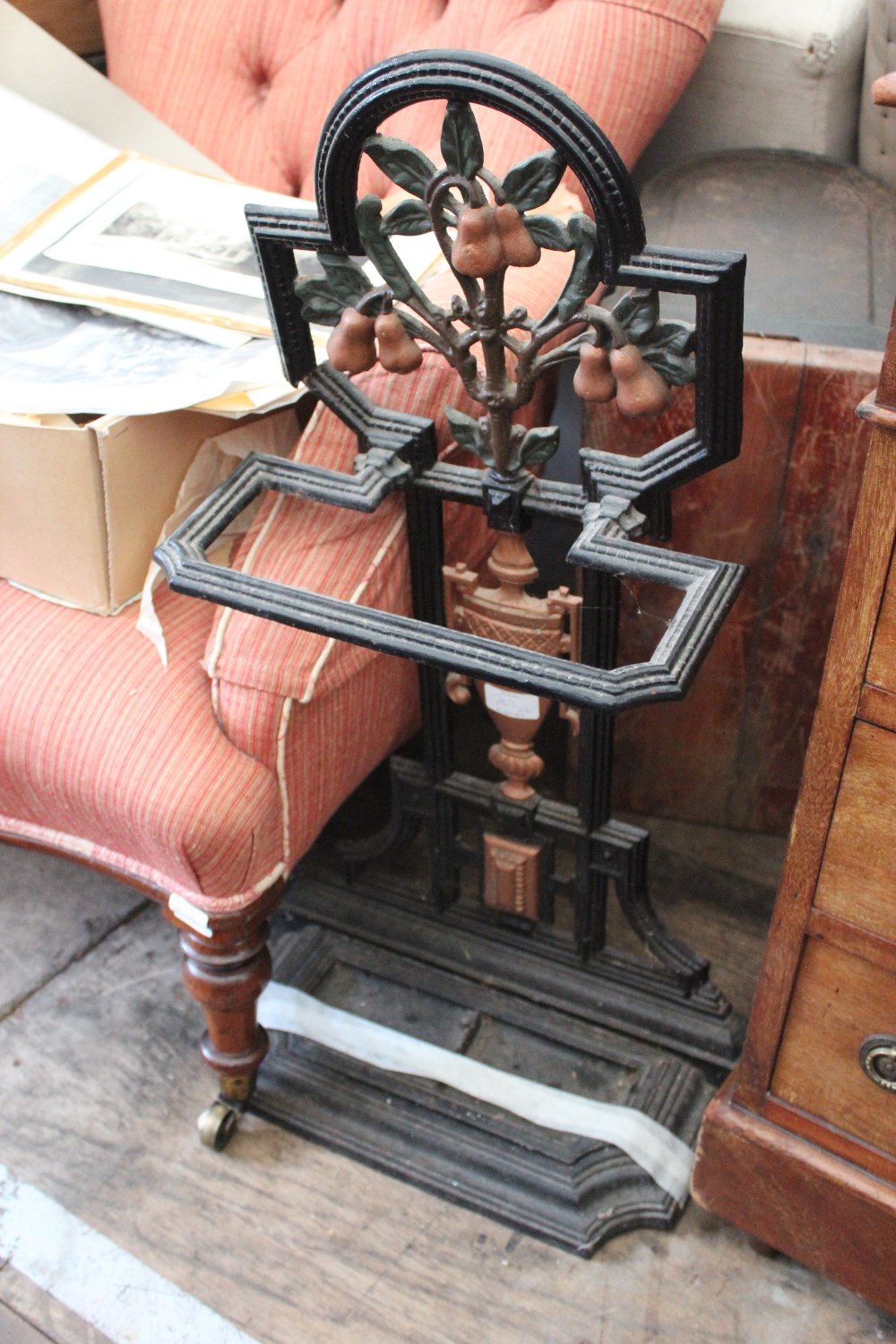 AN OLD SEWING MACHINE together with an old black painted cast iron stick stand (2)