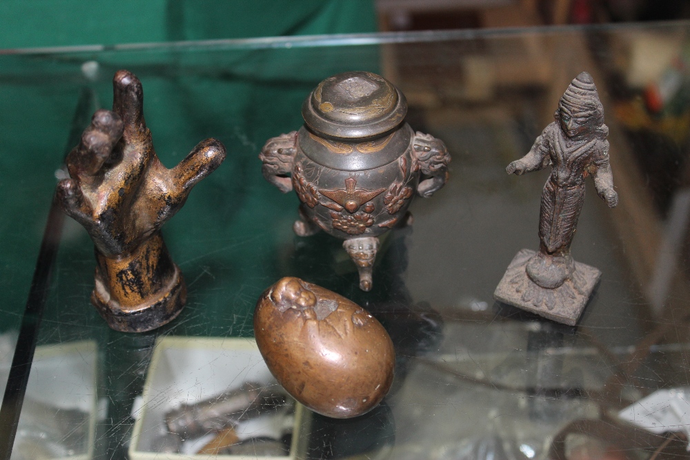 A CAST IRON RING HOLDER in the form of a hand 11.5cm high together with a small bronze sculpture