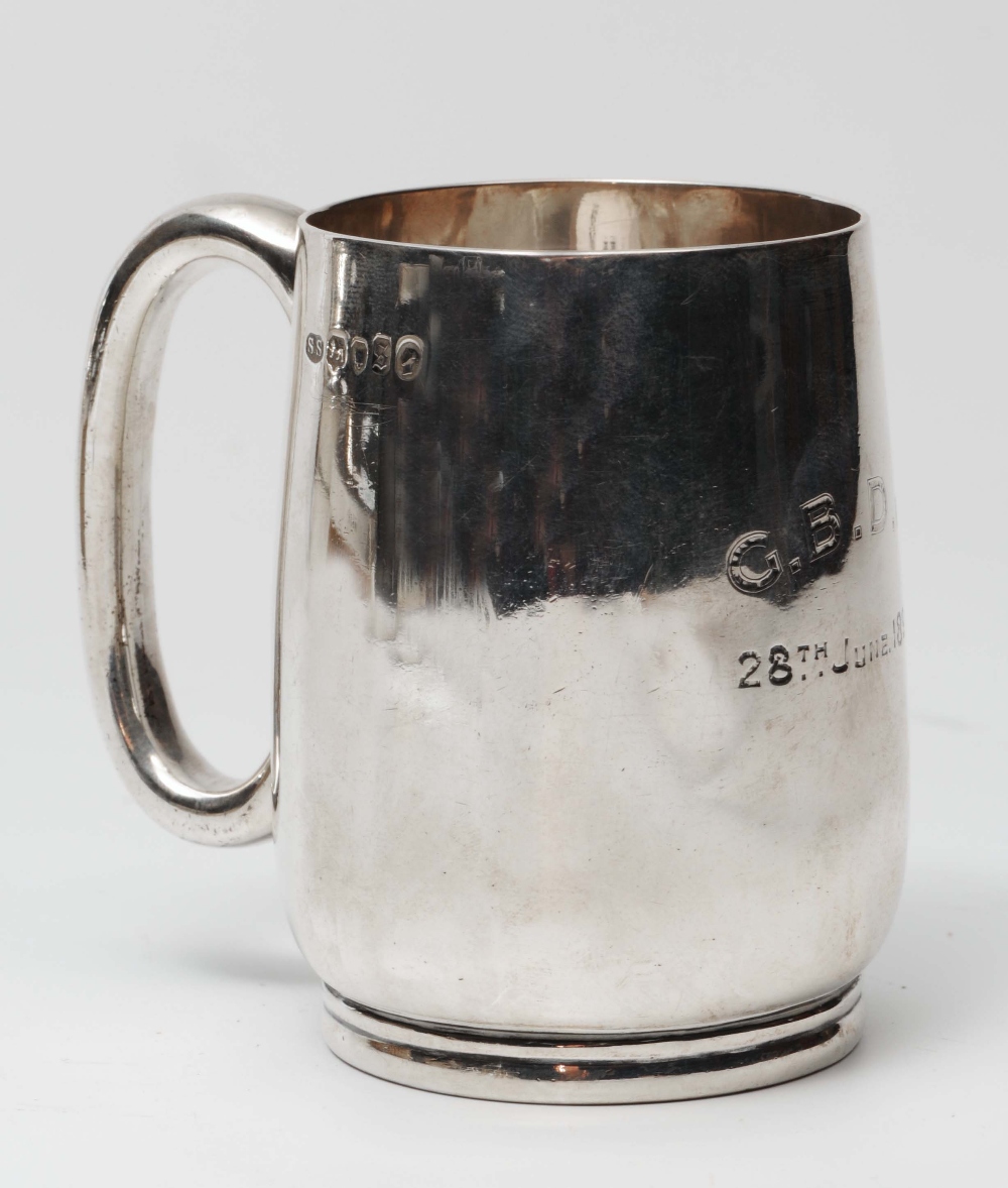 A VICTORIAN SILVER CHRISTENING MUG of plain form with a `C` shaped handle, 3" high, London 1873 by