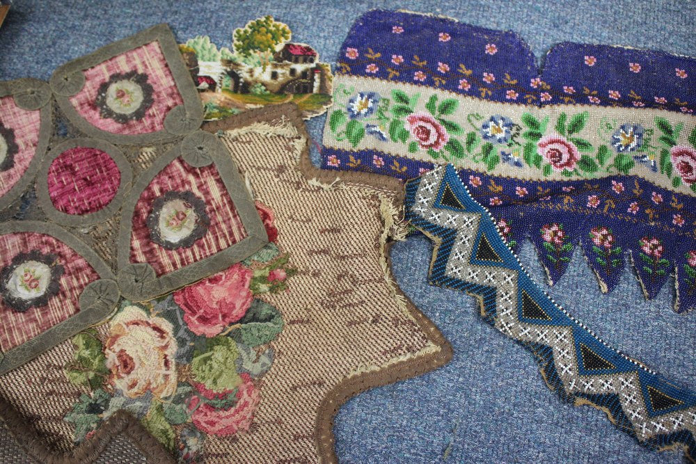 A 19TH CENTURY BEADWORK PANEL with floral banded decoration and kid leather backing 33cm wide