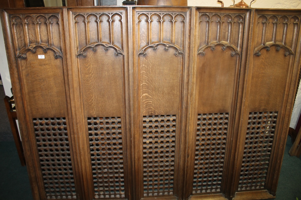 A CARVED OAK ROOD SCREEN with Gothic style carved arched panels, 183cm x 143cm