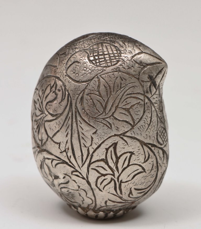 A MUGHAL SILVER OPIUM HOLDER in the form of a mango, decorated with leaf and vines, early 18th