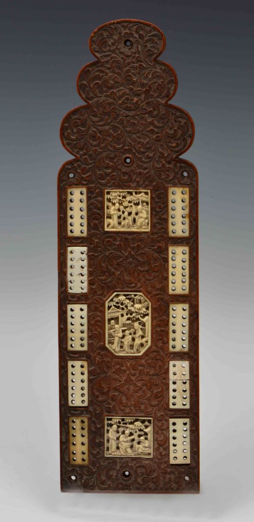 A CHINESE CARVED BOXWOOD CRIB BOARD with inset carved ivory panels, late 19th Century, 26cm long