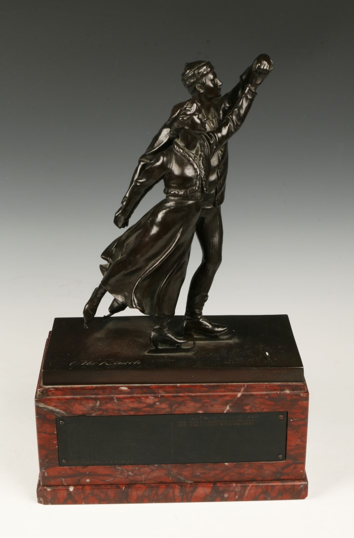 OTTO RIESCH A bronze group of two skaters on a rouge marble plinth with presentation inscription `
