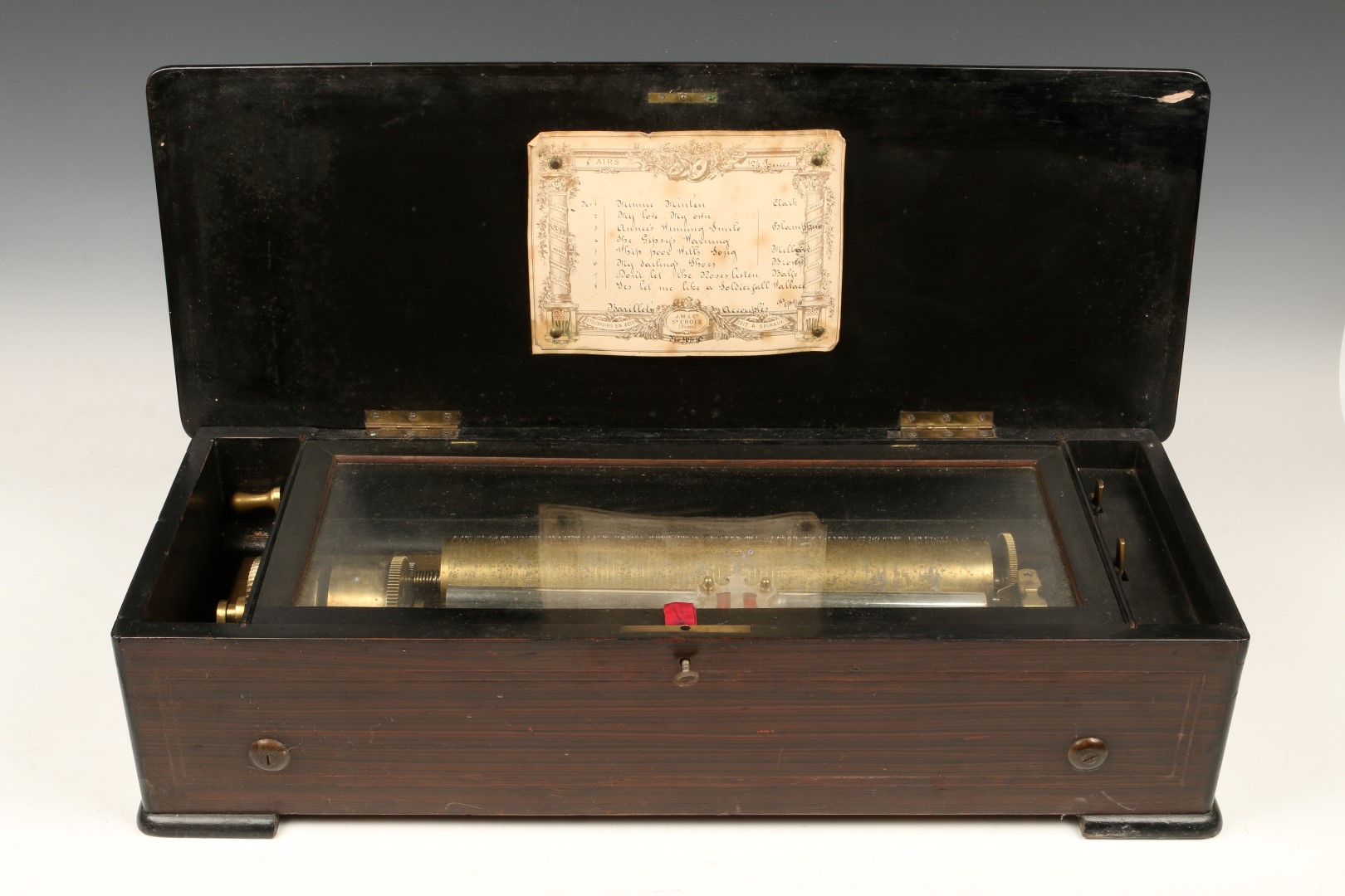 A SWISS MUSICAL BOX playing eight airs by J.M. & Co, Ste. Croix, the rosewood case with marquetry