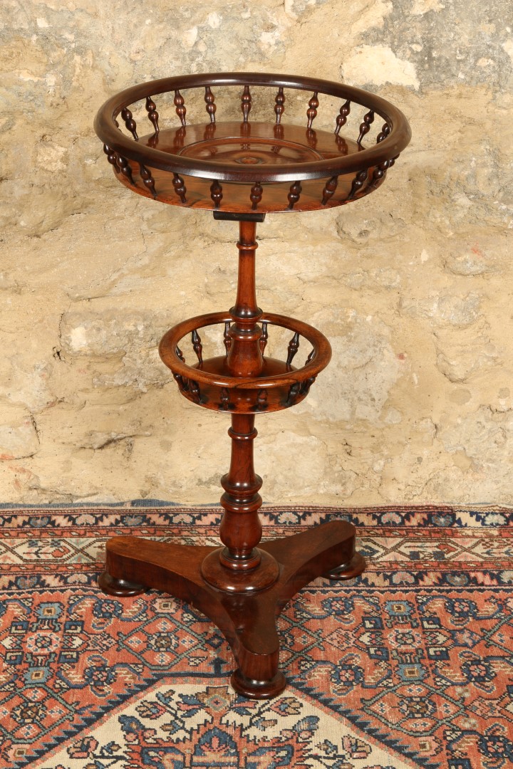 AN EARLY VICTORIAN ROSEWOOD TWO TIER CIRCULAR WINE TABLE with spindle galleries and triform base,