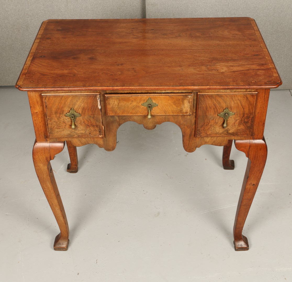 AN OLD REPRODUCTION QUEEN ANNE STYLE WALNUT LOW BOY fitted one long and two deep drawers with brass