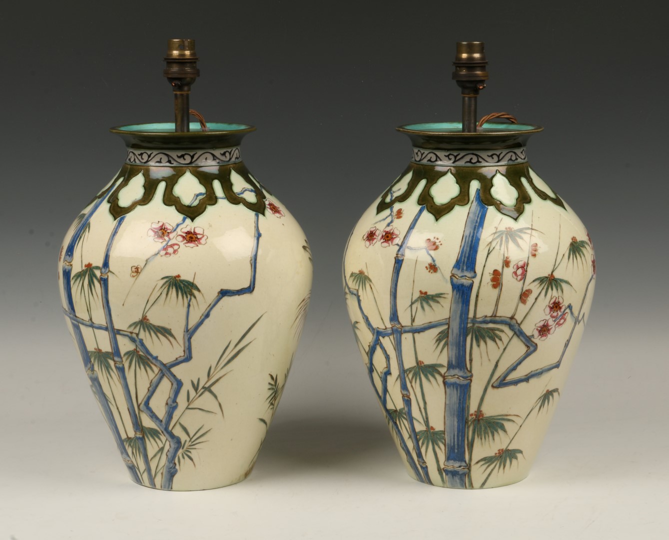 A PAIR OF FRENCH PAINTED POTTERY BALUSTER LAMPS with oriental bird and foliate decoration, 30cm