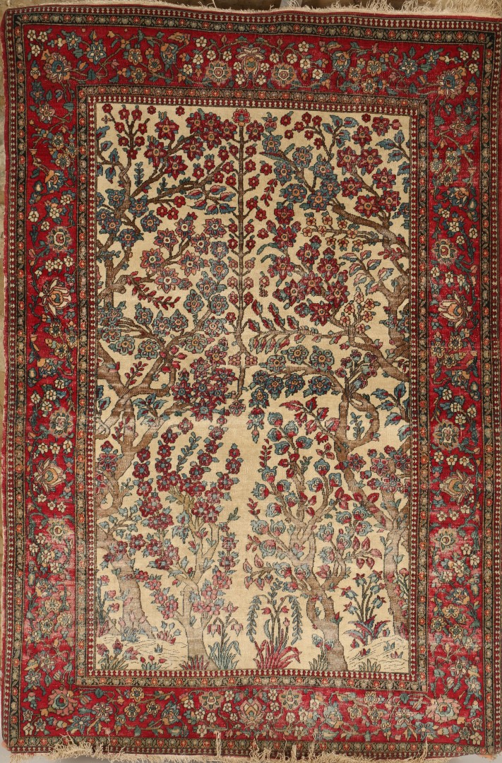 A PERSIAN WHITE GROUND PICTORIAL RUG with central flowering tree motif within a red ground border,