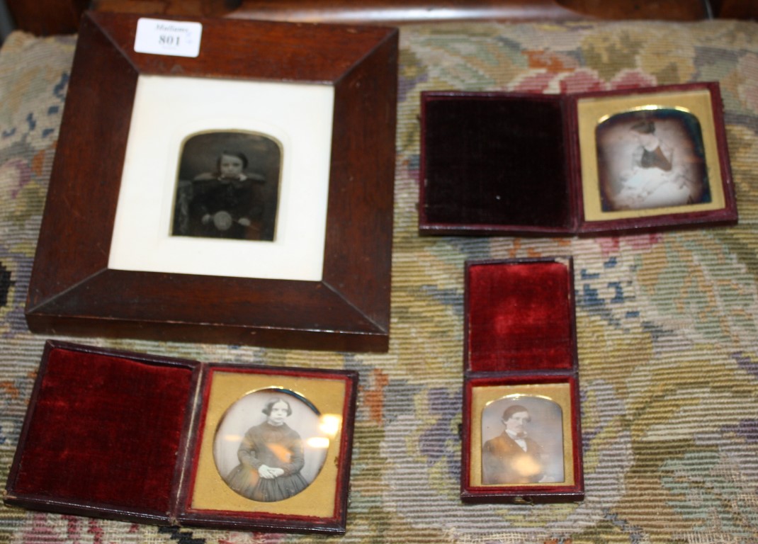 A COLLECTION OF THREE DAGUERROTYPES, portrait studies and an ambrotype portraying a boy with a