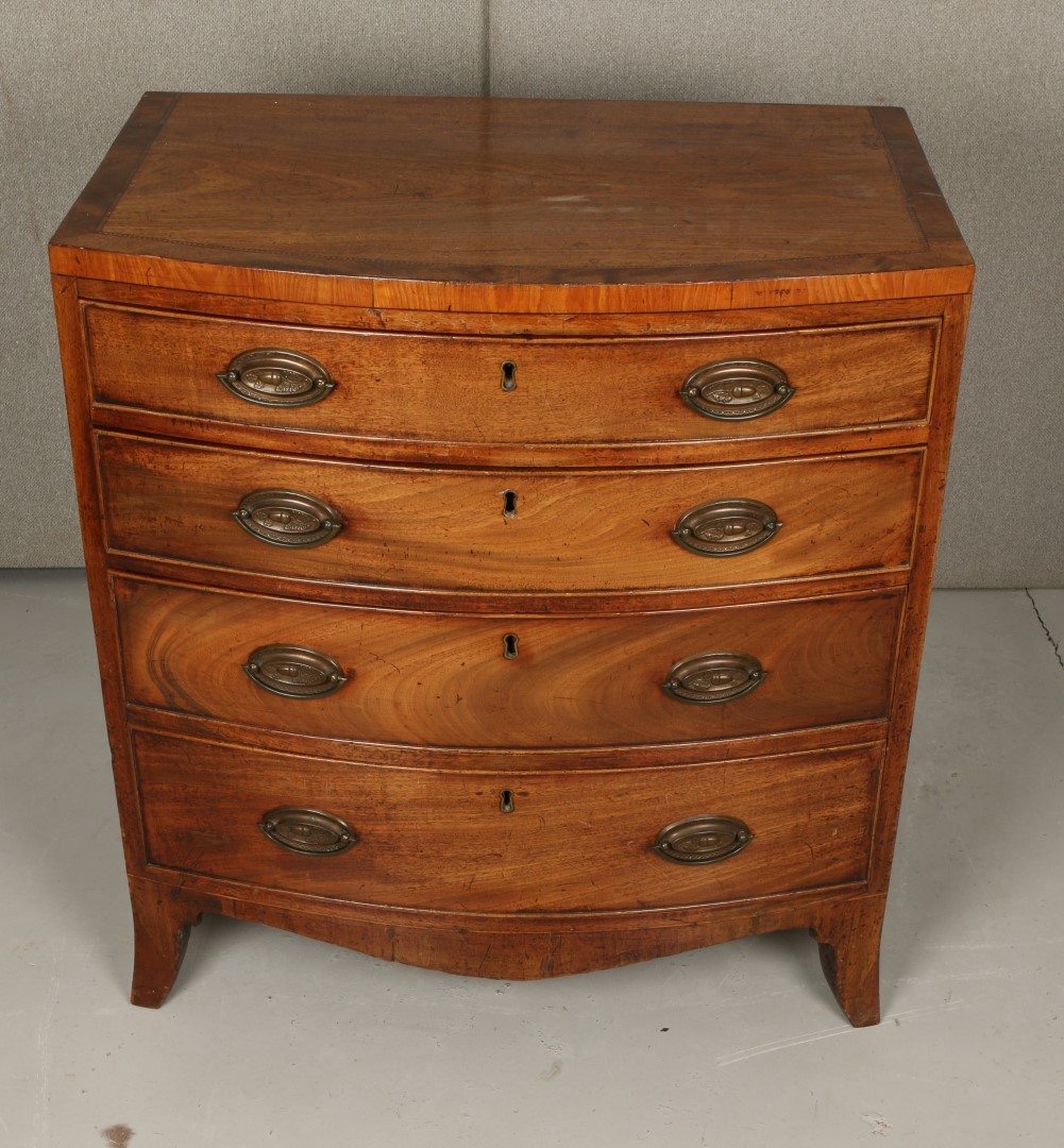 A GEORGE III MAHOGANY SMALL BOW FRONT CHEST of four long graduated drawers with inlaid decoration,