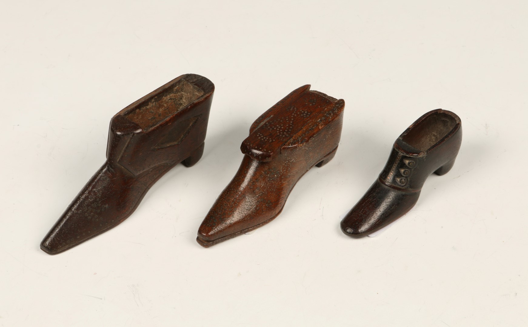 AN 18TH CENTURY WOODEN SHOE SNUFF BOX with inlaid sliding lid, 9.5cm long and two similar (3)