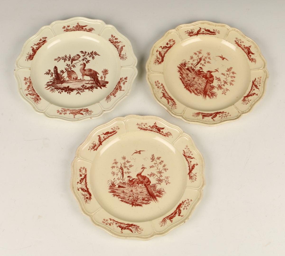 A SET OF THREE ENGLISH CREAMWARE SCALLOP EDGE PLATES with transfer printed oriental pheasant