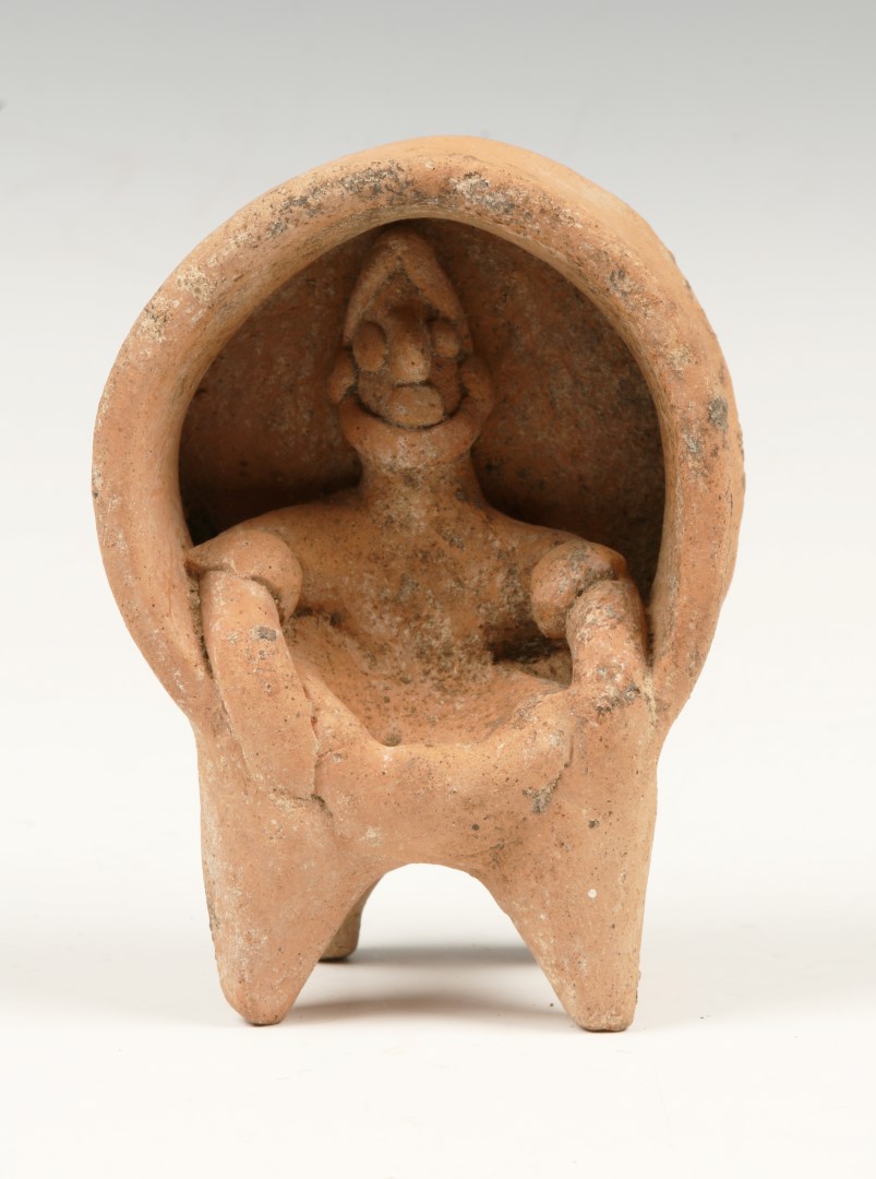 A WEST MEXICO TERRACOTTA FIGURE of a man seated in a throne like chair c1000AD, 10cm high