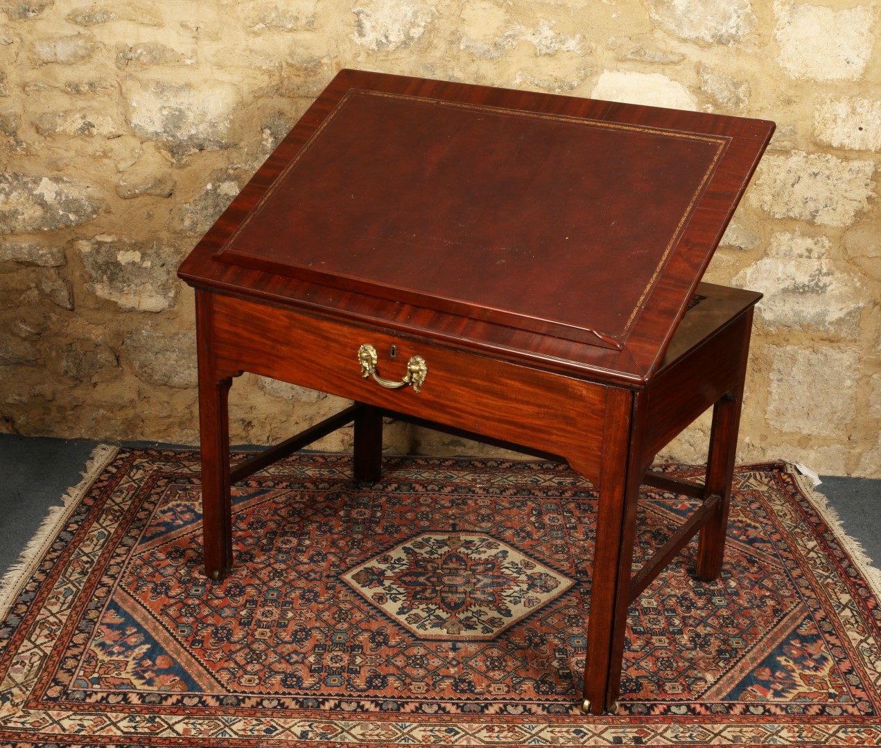 A GEORGE III MAHOGANY ARCHITECTS TABLE with hinged top and fitted pull out writing slide with brass