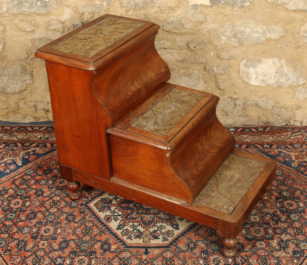 A SET OF VICTORIAN THREE TREAD MAHOGANY BED STEPS with carpet lined treads and turned legs, 50cm