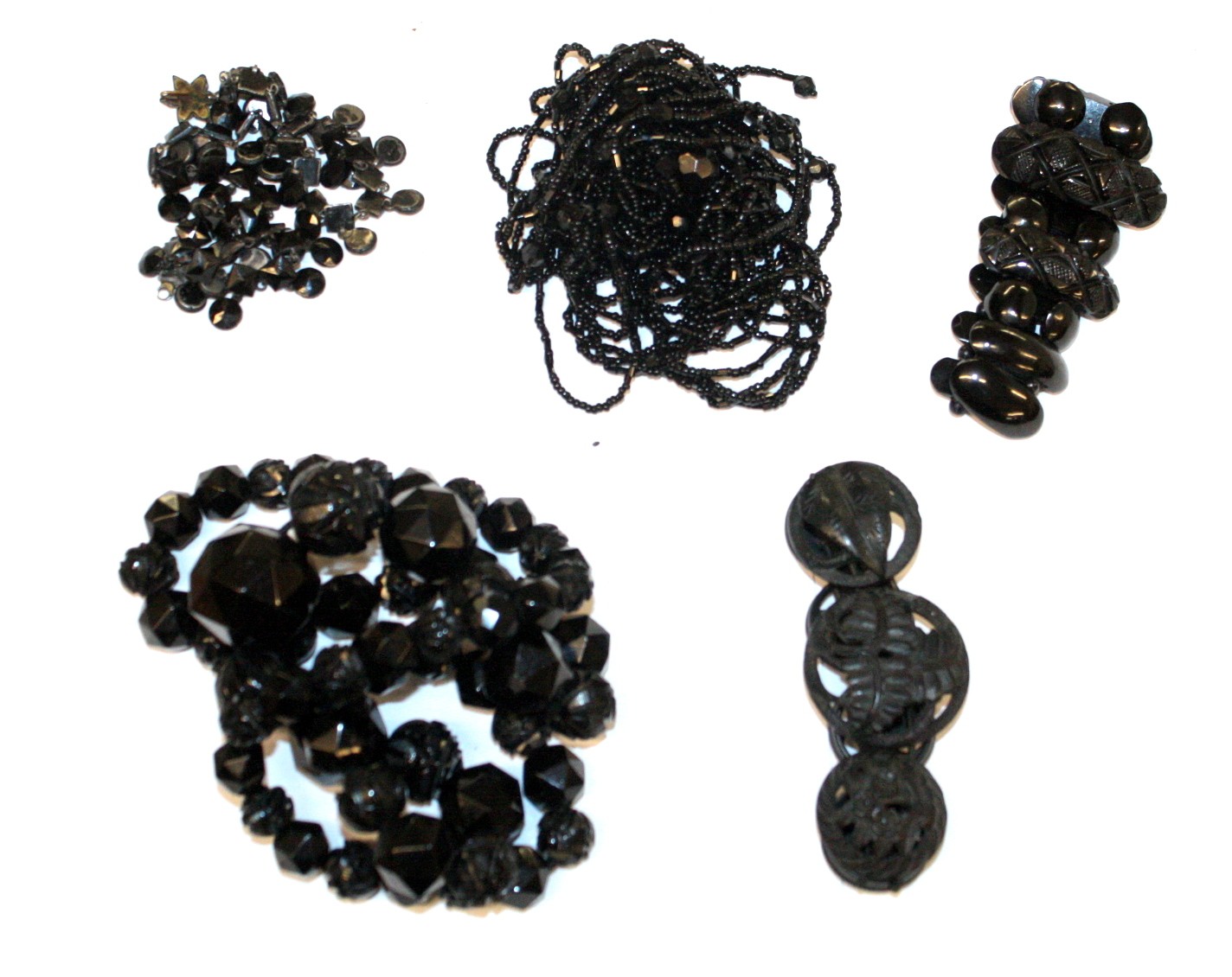 A VICTORIAN JET BEAD NECKLACE with graduated facetted beads with carved beads decorated with flowers