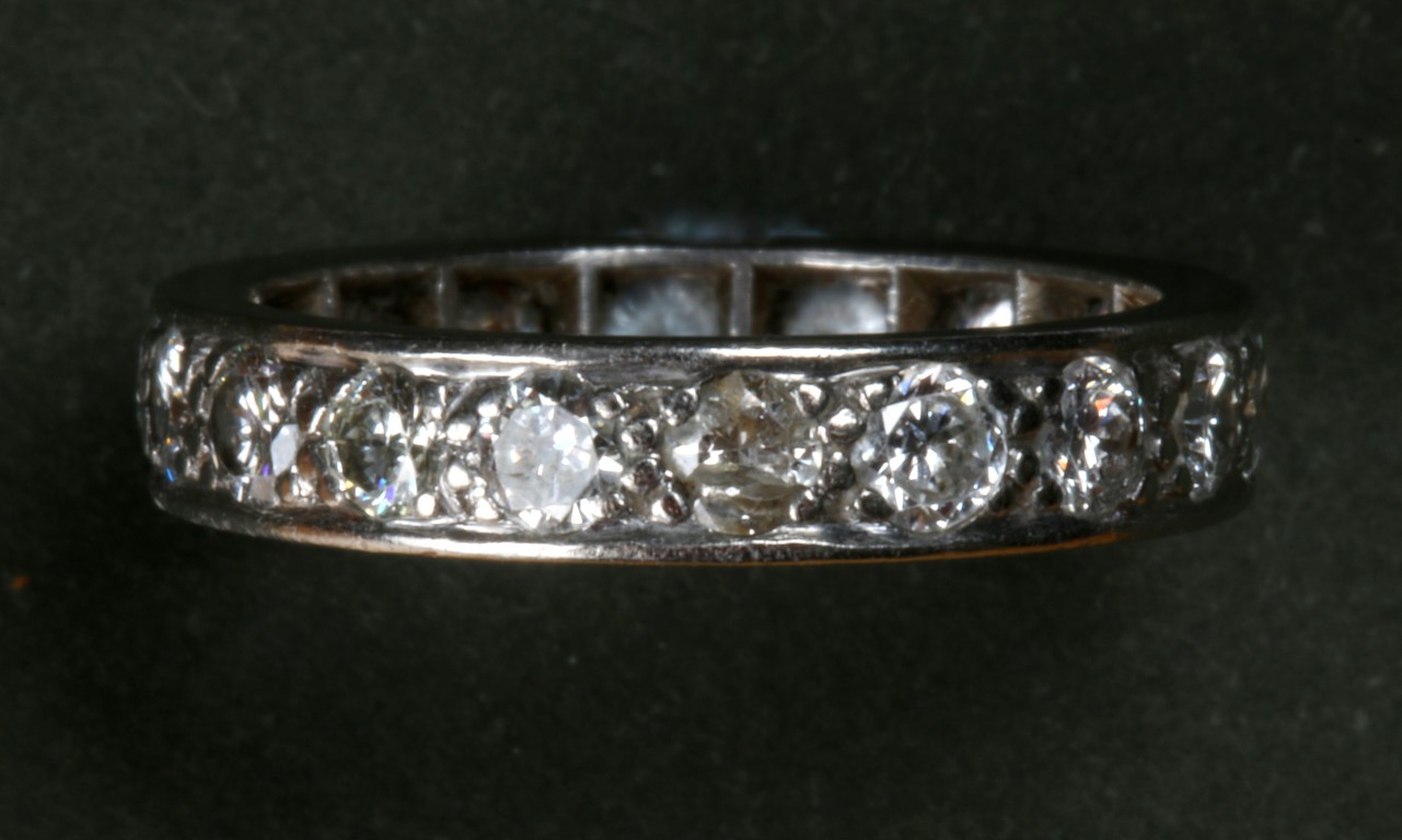 A DIAMOND SET FULL ETERNITY RING with bead set brilliant cut diamonds