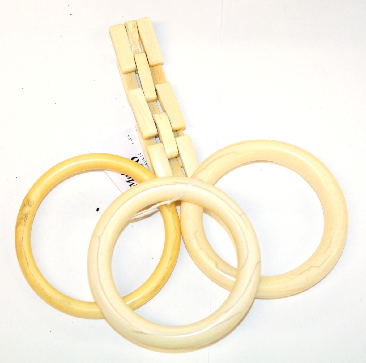 THREE PLAIN IVORY BRACELETS and a bone panelled bracelet (4)