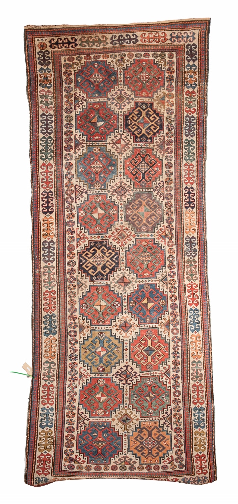 A CAUCASIAN KUBA RUNNER with a multiple multi-coloured design of hooked medallions within a triple