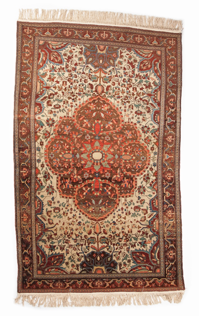 AN AMRITISAR WHITE GROUND RUG with a central foliate medallion within a scrolling border, 200 x