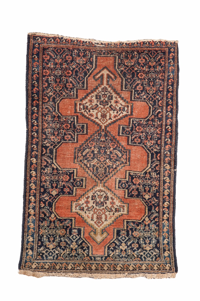 A SENNEH MAT with central interlinked medallion on a brick red ground, 95 x 63cm