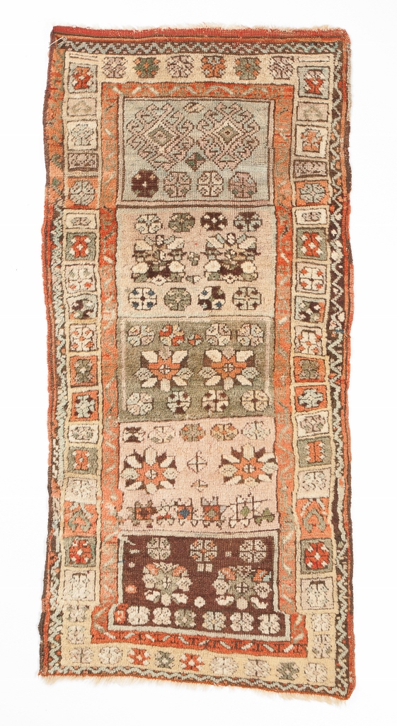 AN OLD YASTIK SMALL RUG with five polychrome panels within a multiple border, 52 x 114cm