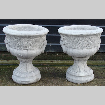 A pair of reconstituted stone garden urns, 64cm tall
